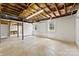 Unfinished basement area with shelving and two windows allowing natural light at 2410 Armstrong Park Dr, Gastonia, NC 28054