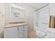 Traditional bathroom featuring a bathtub-shower combo, a single vanity, and white tiling throughout at 2410 Armstrong Park Dr, Gastonia, NC 28054