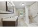 Bathroom featuring wallpaper, a marble shower, and wood trimmed mirror at 2410 Armstrong Park Dr, Gastonia, NC 28054