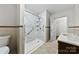 Bathroom featuring a walk-in shower with grab bars and seating, and a marble countertop sink at 2410 Armstrong Park Dr, Gastonia, NC 28054