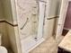 Well-lit bathroom featuring a walk-in shower with grab bars and attractive marble-look tile at 2410 Armstrong Park Dr, Gastonia, NC 28054