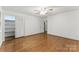 Spacious bedroom boasts hardwood floors, a ceiling fan, and a closet with white bi-fold doors at 2410 Armstrong Park Dr, Gastonia, NC 28054