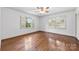 Bright bedroom featuring hardwood floors, shutters on windows, and a ceiling fan at 2410 Armstrong Park Dr, Gastonia, NC 28054