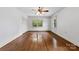 Spacious bedroom featuring hardwood floors, neutral paint, and a ceiling fan with lighting at 2410 Armstrong Park Dr, Gastonia, NC 28054
