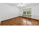 Cozy bedroom with built-in shelving, hardwood floors, and a ceiling fan at 2410 Armstrong Park Dr, Gastonia, NC 28054
