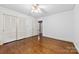Bedroom features hardwood floors, ample closet space, and a ceiling fan at 2410 Armstrong Park Dr, Gastonia, NC 28054