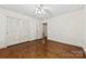 Bedroom with hardwood floors, closet, and entry door at 2410 Armstrong Park Dr, Gastonia, NC 28054