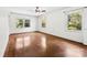 Well-lit bedroom features hardwood floors and windows offering views of the landscaped yard and natural light at 2410 Armstrong Park Dr, Gastonia, NC 28054