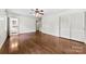 Bedroom with hardwood floors, a ceiling fan, and an ensuite bathroom providing convenience and privacy at 2410 Armstrong Park Dr, Gastonia, NC 28054