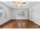 Bedroom with hardwood floors, plantation shutters, and a closet with louvered doors at 2410 Armstrong Park Dr, Gastonia, NC 28054