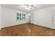 Bedroom features hardwood flooring, a ceiling fan, and bright windows with backyard views at 2410 Armstrong Park Dr, Gastonia, NC 28054