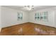 Bright bedroom with hardwood floors and windows dressed with shutter-style blinds at 2410 Armstrong Park Dr, Gastonia, NC 28054