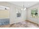 Sunny dining room features neutral paint, chair rail, decorative chandelier, and multiple windows at 2410 Armstrong Park Dr, Gastonia, NC 28054