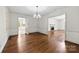 Open-concept dining room with hardwood floors, access to the kitchen, and natural light at 2410 Armstrong Park Dr, Gastonia, NC 28054