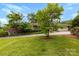 Brick home with mature trees and a long driveway that leads to a two-car garage at 2410 Armstrong Park Dr, Gastonia, NC 28054