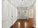 Bright foyer features hardwood floors, a white front door with sidelights, and classic overhead lighting fixture at 2410 Armstrong Park Dr, Gastonia, NC 28054