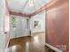 Foyer featuring hardwood floors, a decorative chandelier, and patterned wallpaper at 2410 Armstrong Park Dr, Gastonia, NC 28054