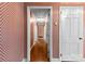 Hallway with hardwood floors, decorative wallpaper, and doors leading to other rooms at 2410 Armstrong Park Dr, Gastonia, NC 28054