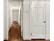 Long hallway with hardwood floors, leading to various rooms in the home at 2410 Armstrong Park Dr, Gastonia, NC 28054