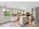 Bright kitchen with white cabinets, stainless appliances, center island, and large window views at 2410 Armstrong Park Dr, Gastonia, NC 28054