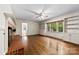 Gathering room features hardwood floors, built-in bookcases, brick fireplace, and outdoor view through large windows at 2410 Armstrong Park Dr, Gastonia, NC 28054