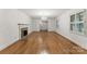Spacious living room featuring hardwood floors, a fireplace, and large windows with natural light at 2410 Armstrong Park Dr, Gastonia, NC 28054