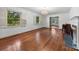 Large living room with hardwood floors, fireplace, white trim, and large windows showing the yard at 2410 Armstrong Park Dr, Gastonia, NC 28054