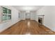 Bright living room with hardwood floors, a fireplace, and windows with views to the outside at 2410 Armstrong Park Dr, Gastonia, NC 28054