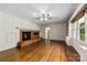 Cozy Gathering room with brick fireplace, hardwood floors, built-in cabinets, and large windows at 2410 Armstrong Park Dr, Gastonia, NC 28054