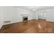 Inviting living room with hardwood floors, a fireplace, and a classic chandelier at 2410 Armstrong Park Dr, Gastonia, NC 28054