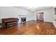 Bright living room with hardwood floors, fireplace, piano, and chandelier at 2410 Armstrong Park Dr, Gastonia, NC 28054