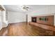 Living room boasts hardwood floors, brick fireplace, access to other rooms, and a wall-mounted tv at 2410 Armstrong Park Dr, Gastonia, NC 28054