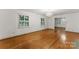 Living room showcasing hardwood floors, natural light, and open layout to dining area at 2410 Armstrong Park Dr, Gastonia, NC 28054