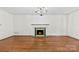 Classic living room with a fireplace, hardwood flooring, and abundant natural light at 2410 Armstrong Park Dr, Gastonia, NC 28054