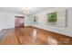 Charming living room with ample natural light, hardwood floors, and vintage decor at 2410 Armstrong Park Dr, Gastonia, NC 28054