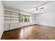 Spacious Gathering room featuring hardwood floors, built-in shelving, white trim, and window views at 2410 Armstrong Park Dr, Gastonia, NC 28054