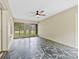 Bright sunroom with flagstone flooring, ceiling fan, and windows overlooking the backyard at 2410 Armstrong Park Dr, Gastonia, NC 28054