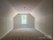 This large attic space has carpeting and a window at 28770 Hwy 73 Hwy, Albemarle, NC 28001