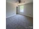 This carpeted bedroom has a ceiling fan and an entrance to another room at 28770 Hwy 73 Hwy, Albemarle, NC 28001