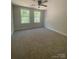 This bedroom has two windows and a ceiling fan at 28770 Hwy 73 Hwy, Albemarle, NC 28001