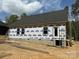 Exterior framing showing the installed windows, door, and weather barrier on this new home construction at 28770 Hwy 73 Hwy, Albemarle, NC 28001