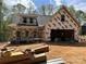 A partially constructed two story home with visible framing, windows, and a two-car garage at 28770 Hwy 73 Hwy, Albemarle, NC 28001