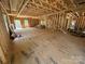 Unfinished interior showcasing wood framing, plywood flooring, and the start of a staircase at 28770 Hwy 73 Hwy, Albemarle, NC 28001
