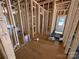 Unfinished interior showing wood studs, plywood flooring, and visible plumbing and electrical elements at 28770 Hwy 73 Hwy, Albemarle, NC 28001