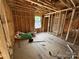 Partially finished room with wooden frame, plywood flooring and a window view at 28770 Hwy 73 Hwy, Albemarle, NC 28001