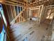 Exposed framing showing ceiling and wall supports in an unfinished room with plywood flooring at 28770 Hwy 73 Hwy, Albemarle, NC 28001