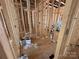 Interior framing with visible studs, plywood flooring, and electrical elements at 28770 Hwy 73 Hwy, Albemarle, NC 28001