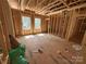 Framed interior featuring exposed wood studs, subflooring, and two bright windows at 28770 Hwy 73 Hwy, Albemarle, NC 28001