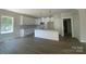 New kitchen features white cabinetry, granite countertops, subway tile backsplash and stainless appliances at 28770 Hwy 73 Hwy, Albemarle, NC 28001