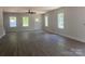 Spacious living room boasts new hardwood flooring and abundant natural light from three windows at 28770 Hwy 73 Hwy, Albemarle, NC 28001